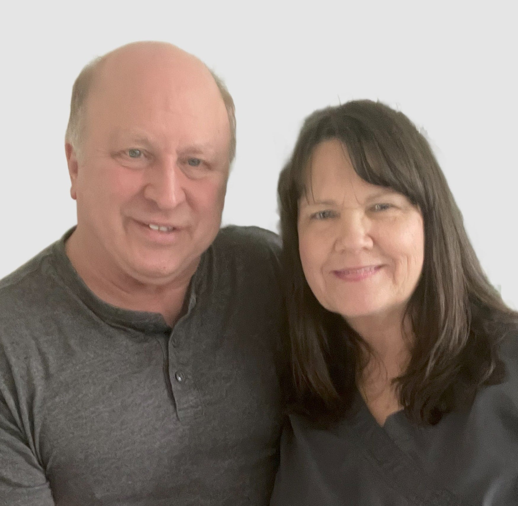 Jeff & Joanne McCreary posing together against a plain background