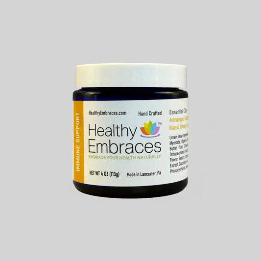 Healthy Embraces immune support cream in a 4oz jar, showing smooth, creamy texture and label on the product container.